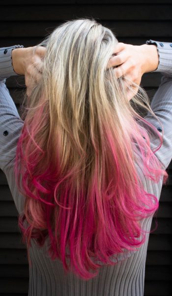 woman-in-gray-long-sleeved-top-holding-hair-1321916